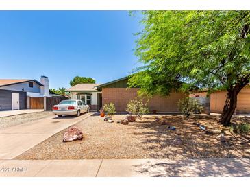 Charming single-story home with a well-maintained front yard and mature landscaping at 1509 E Verlea Dr, Tempe, AZ 85282