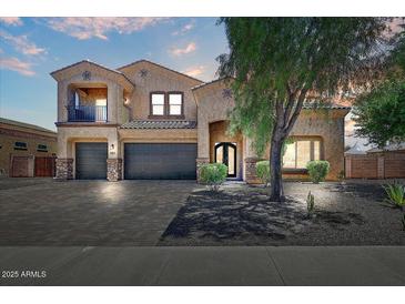 Charming two-story stucco home featuring a three-car garage and inviting curb appeal at 18207 W Sells Dr, Goodyear, AZ 85395