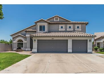 Charming two-story home featuring a three-car garage and tile roof at 1847 W Leah Ln, Gilbert, AZ 85233
