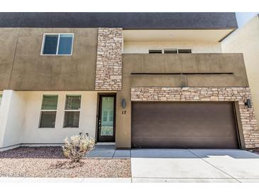 Contemporary two-story home featuring stone accents, a dark roof, and an integrated two-car garage at 2000 N 36Th St # 17, Phoenix, AZ 85008