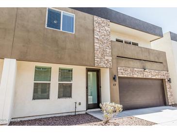 Modern two-story townhome with mixed material facade featuring stone and an attached two-car garage at 2000 N 36Th St # 17, Phoenix, AZ 85008