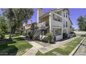 Inviting condo exterior showcasing staircase access and manicured landscaping at 2333 E Southern Ave # 1015, Tempe, AZ 85282