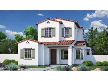 Charming two-story home with a red tile roof, shuttered windows, and beautifully landscaped front yard at 26433 N 22Nd Dr, Phoenix, AZ 85085