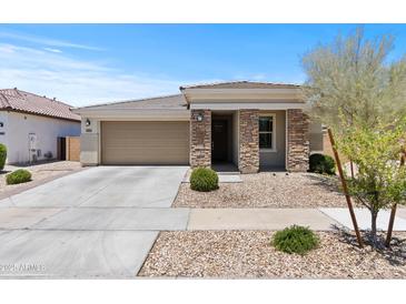 Charming single-story home with stone accents, low maintenance front yard, and two-car garage at 18854 W Poinsettia Dr, Surprise, AZ 85388