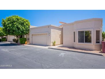 Charming single-story home featuring a private garage and well-maintained landscaping at 2647 N Miller Rd # 6, Scottsdale, AZ 85257
