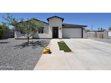 Charming single-story home with a low-maintenance landscaped yard, complemented by a modern, attached two-car garage at 2790 W Cholla St, Apache Junction, AZ 85120