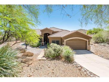 Stunning single-story home featuring a tile roof, low-maintenance landscaping, and an attached two-car garage at 33823 N 2Nd St, Phoenix, AZ 85085