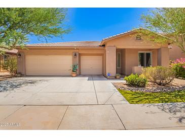 Charming single-story home featuring a three-car garage and desert landscaping at 7413 W Southgate Ave, Phoenix, AZ 85043