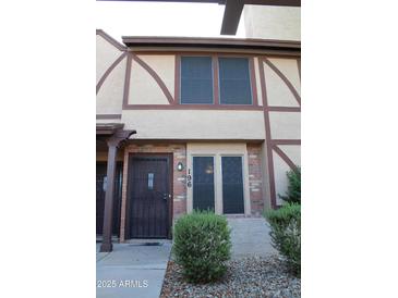Charming townhome featuring a secure front entry and manicured landscaping at 7977 W Wacker Rd # 196, Peoria, AZ 85381