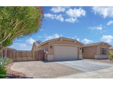 Charming single-story home with desert landscaping and a two-car garage, set against a beautiful blue sky at 1101 W Oleander Ave, Queen Creek, AZ 85140