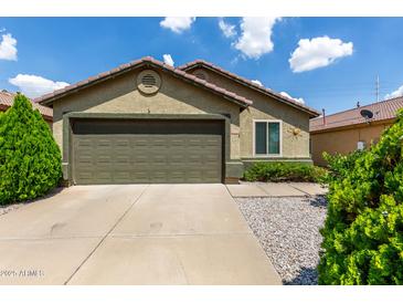 Charming single-story home featuring a well-maintained front yard with a two-car garage and neutral toned paint at 16833 N 113Th Ave, Surprise, AZ 85378