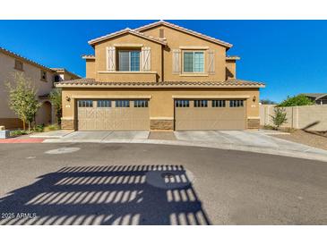 Inviting two-story home featuring a two-car garage, classic shutters, and charming curb appeal at 2254 E University Dr # 4, Mesa, AZ 85213