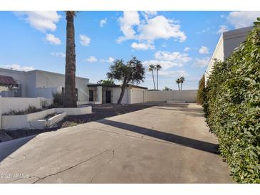 Charming single-story home with desert landscaping and a spacious driveway on a sunny day at 3218 W Clinton St, Phoenix, AZ 85029