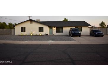 Charming single-story home featuring a well-kept yard and a lovely desert landscape at 4755 E Gary St, Mesa, AZ 85205