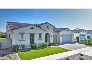 Charming single story home with manicured front yard, paver driveway, and classic Southwestern architecture at 10643 E Tumbleweed Ave, Mesa, AZ 85212