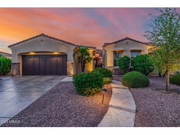 Charming home exterior with desert landscaping and a tile roof in a warm sunset glow at 13716 W Nogales Dr, Sun City West, AZ 85375