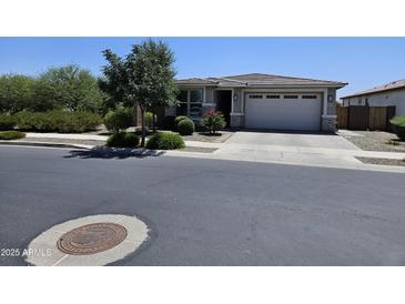 Charming single-story home with a well-manicured front yard and a two-car garage at 18871 S 209Th Way, Queen Creek, AZ 85142