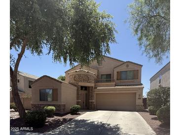 Charming two-story home featuring a stone accent wall, balcony, and a well-manicured front yard at 21280 N 96Th Ave, Peoria, AZ 85382