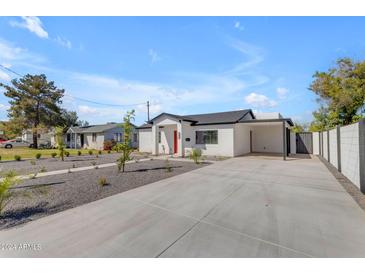 Inviting single-story home featuring a neutral color palette, low maintenance yard, and a concrete driveway at 2402 N 15Th St, Phoenix, AZ 85006