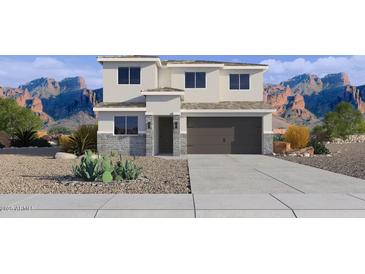 Charming two-story home with desert landscaping, stone accents, and an attached two-car garage at 24236 W Southgate Ave, Buckeye, AZ 85326