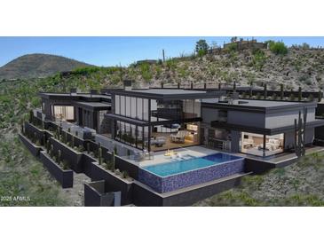 Stunning contemporary home featuring a backyard pool and elevated fire pit at 39307 N Silver Saddle Dr, Carefree, AZ 85377