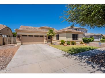 Charming single-story home featuring a well-manicured lawn, desert landscaping, and a spacious two-car garage at 4235 S Snowcap Dr, Gilbert, AZ 85297
