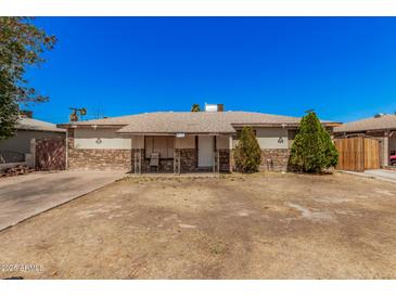 Charming single-story home featuring a stone accent facade and tidy front yard at 4403 N 48Th Dr, Phoenix, AZ 85031