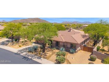 Attractive single-story home with desert landscaping, mature trees, and a tile roof in an upscale community at 7283 E Brisa Dr, Scottsdale, AZ 85266