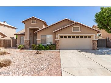 Charming single-story home featuring desert landscaping and a two-car garage at 8343 W Paradise Dr, Peoria, AZ 85345