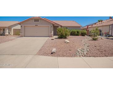 Charming single-story home with a well-maintained front yard, complemented by a two-car garage and a beautiful desert landscape at 11352 E Dartmouth St, Mesa, AZ 85207