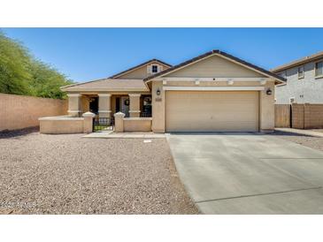 Charming single-Gathering home with a two-car garage, inviting front porch, and low-maintenance desert landscaping at 1397 E Laurel Pl, Casa Grande, AZ 85122