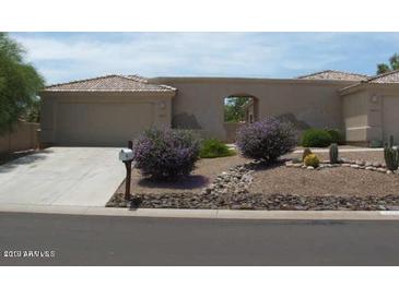 A single story home featuring a stucco exterior, a two car garage, and desert landscaping in the front yard at 14214 N Galatea Dr # A, Fountain Hills, AZ 85268
