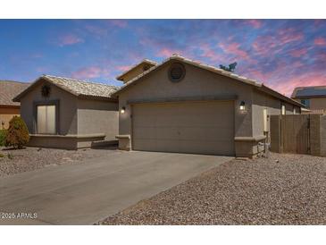 Charming single-story home featuring a two-car garage, desert landscaping, and a neutral color palette at 1564 E Leaf Rd, San Tan Valley, AZ 85140
