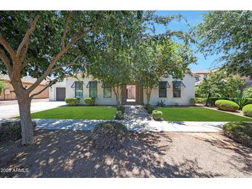 Charming single-story home featuring lush landscaping and a well-manicured lawn at 2859 E Los Altos Rd, Gilbert, AZ 85297
