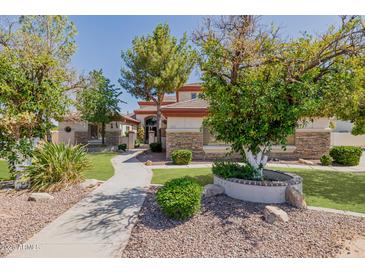 Beautiful single-Gathering home featuring a well-manicured lawn and mature trees in a desirable neighborhood at 3955 E Fox Cir, Mesa, AZ 85205