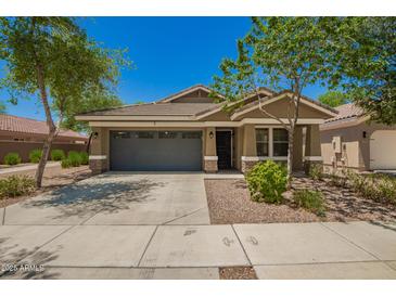 Charming single-story home with a well-maintained lawn and a two-car garage at 4241 E Bonanza Rd, Gilbert, AZ 85297