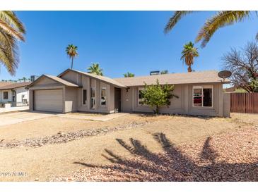 Charming single-story home with desert landscaping and attached two-car garage at 10115 W Turney Ave, Phoenix, AZ 85037