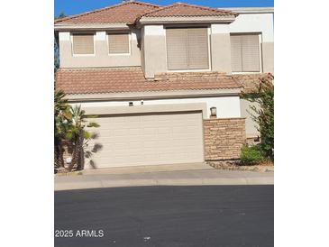 Inviting two-story home with a two-car garage and a well-maintained yard with desert landscaping at 1257 E Voltaire Ave, Phoenix, AZ 85022