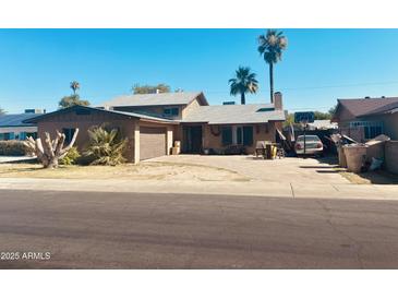 Charming single-Gathering home featuring desert landscaping, a two-car garage, and a classic architectural style at 4316 W Rose Ln, Glendale, AZ 85301