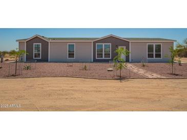 Charming single-Gathering home with rock landscaping and a walkway leading to the front door at 873 N Windy Meadow Ln, Maricopa, AZ 85139