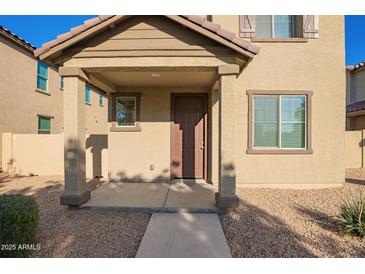 Inviting front porch with stylish supports and desert landscaping at 909 E Agua Fria Ln, Avondale, AZ 85323