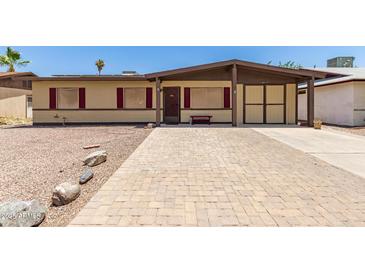 Charming single-story home featuring a low-pitched roof and a quaint brick driveway for curb appeal at 18217 N 34Th Ave, Phoenix, AZ 85053
