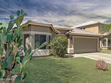 Charming single-story home with well-maintained lawn, desert landscaping, and an attached two-car garage at 45726 W Long Way, Maricopa, AZ 85139