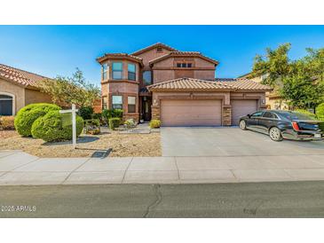 Charming two-story home with a three-car garage, tile roof, and well-manicured landscaping at 7246 W Monte Cristo Ave, Peoria, AZ 85382