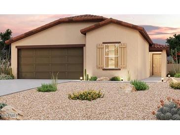 Charming single-story home featuring a desert landscape, a two-car garage, and a warm, inviting facade at 7891 S Summit Dr, Casa Grande, AZ 85193