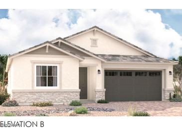 Charming single-story home featuring neutral stucco, a stone facade, and a two-car garage at 8325 N 53Rd Dr, Glendale, AZ 85302