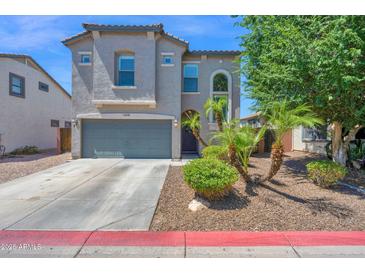 Beautiful two-story home with a gray stucco exterior, landscaped yard, and a two-car garage at 9918 E Escondido Ave, Mesa, AZ 85208