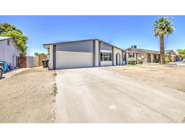 Charming single-story home featuring neutral paint, attached two-car garage, and a long driveway at 14014 N 39Th Ave, Phoenix, AZ 85053