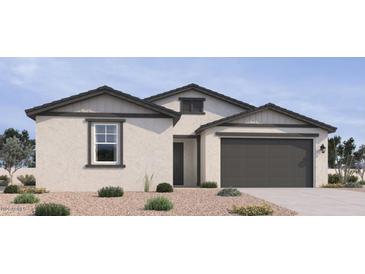 Charming single-story home with neutral stucco, complemented by grey accents and a two-car garage at 15731 W Brown St, Waddell, AZ 85355