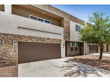 Contemporary two-story home featuring a two-car garage and stone accents at 2000 N 36Th St # 30, Phoenix, AZ 85008